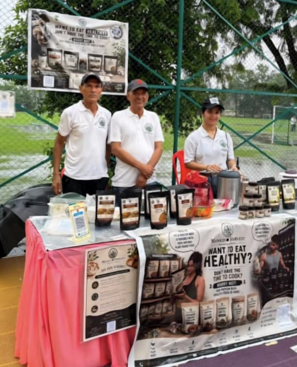 The founder with her father and uncle behind the Manico Harvest stall