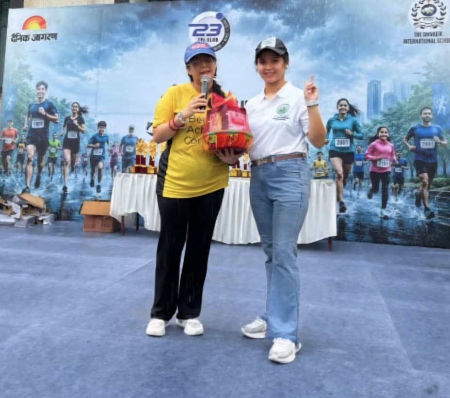Presenting a Manico Harvest Healthy Hamper on stage at the Rain Run Haldwani