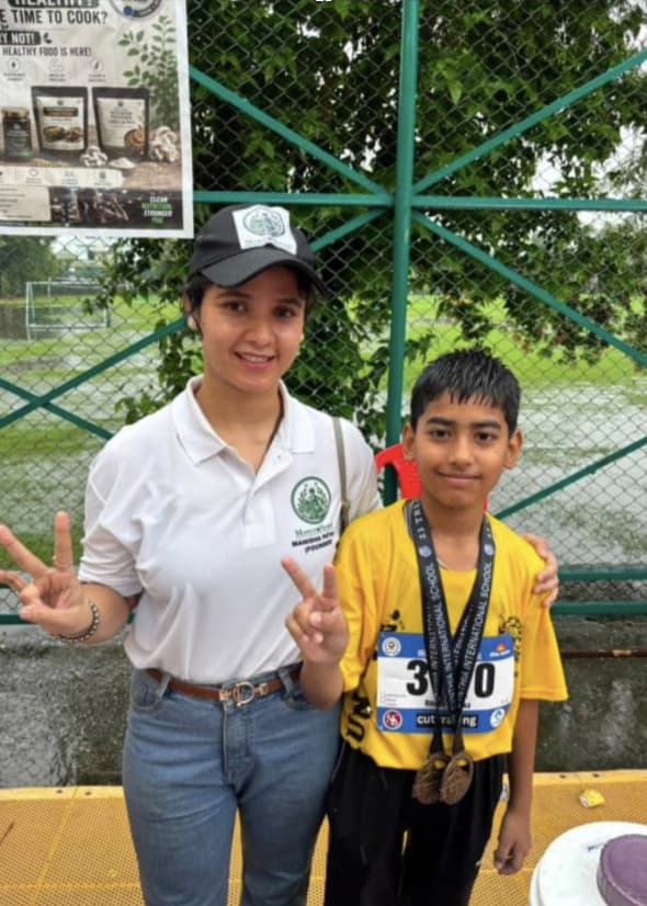 Founder with a young runner wearing his finisher medals